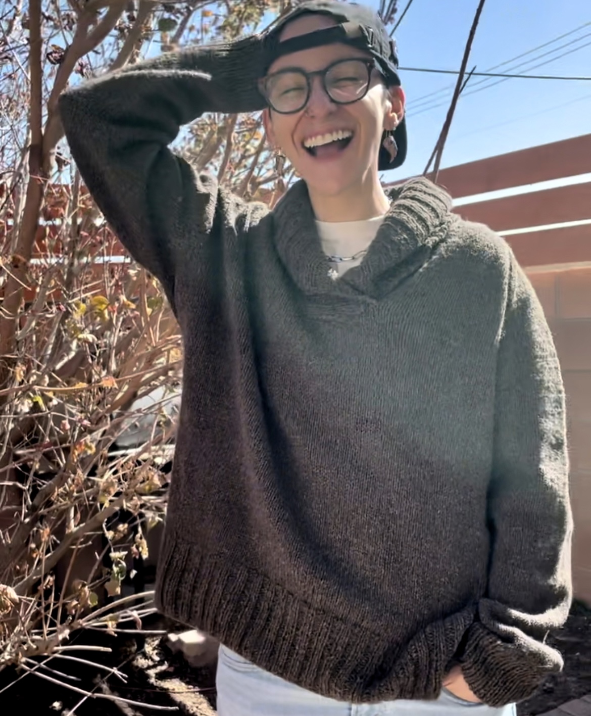 me smiling in a brown cowl neck sweater